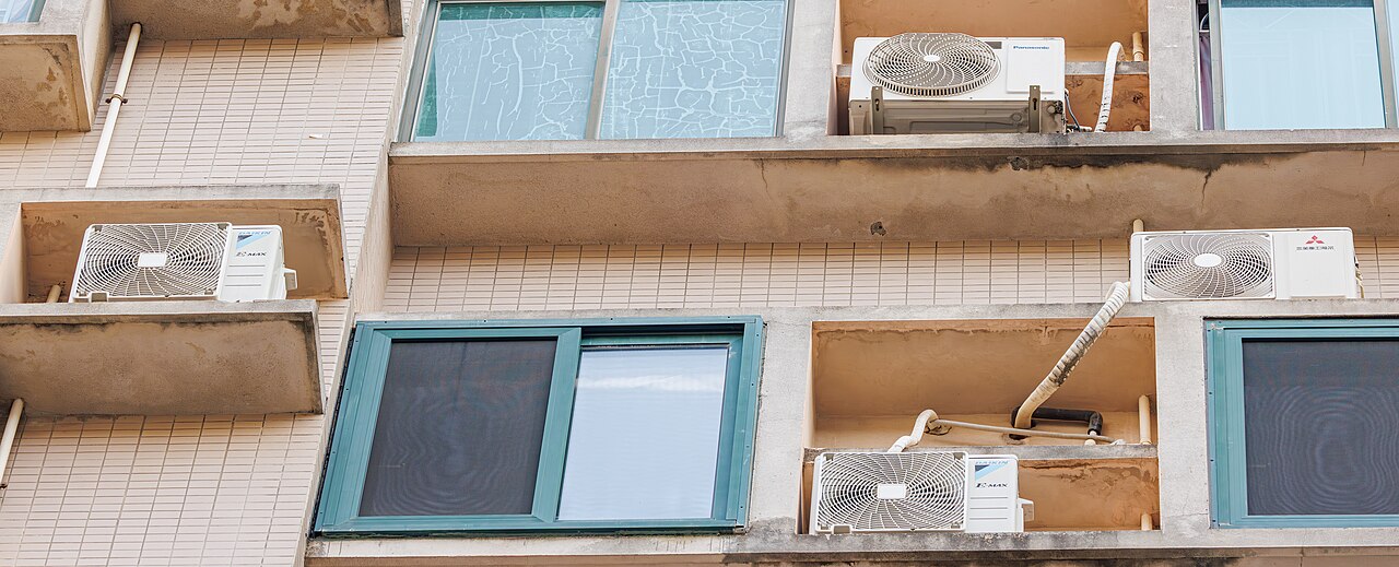 Outdoor AC condenser units mounted on a building exterior